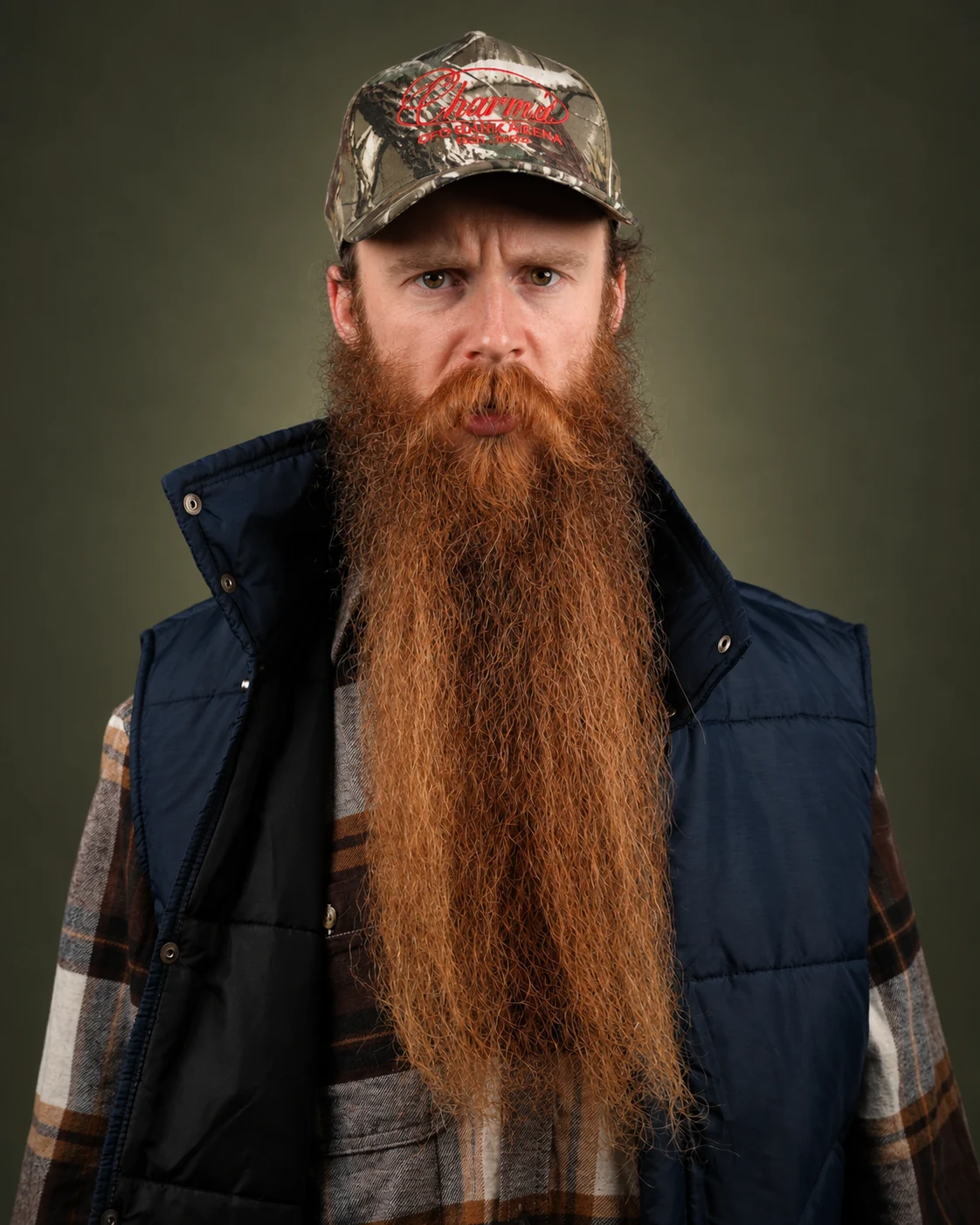 London Oliver in a camouflage cap and dark vest