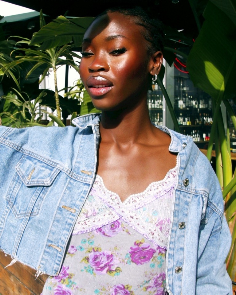 Close-up fashion portrait in denim surrounded by city greenery