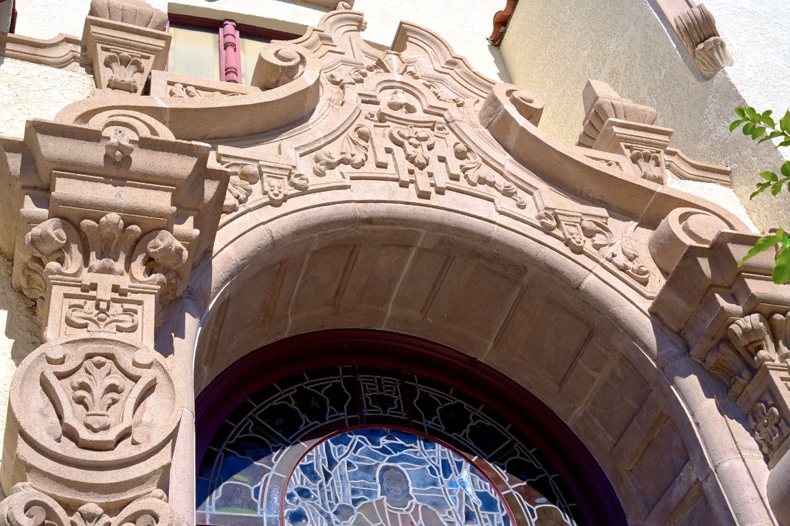 Intricate stone facade and arched church doorway