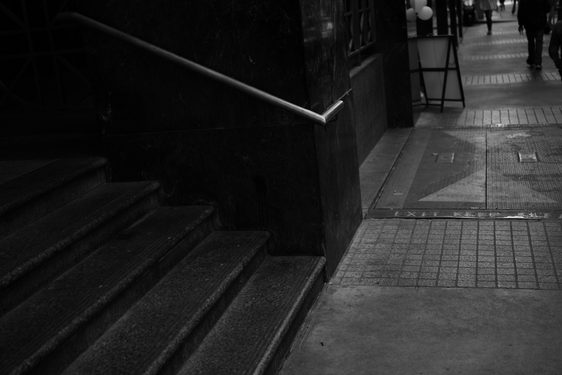 Shadowed downtown stairwell and sidewalk